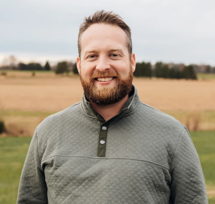 Nicholas Brand standing in a field
